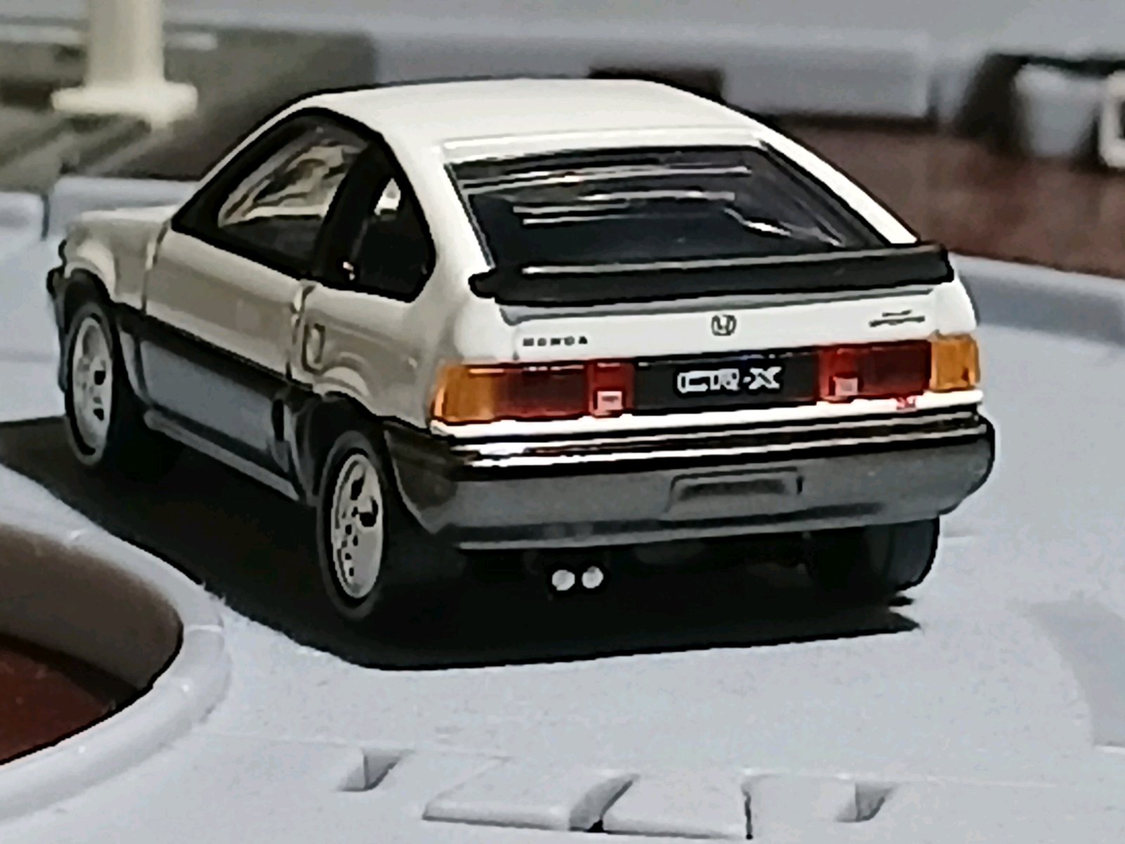 タカラトミーモール限定のホンダ バラードスポーツCRX Siのミニカー後方写真。白と黒のツートン仕様で、リアに「HONDA」「CRX Si」の表記が見える。